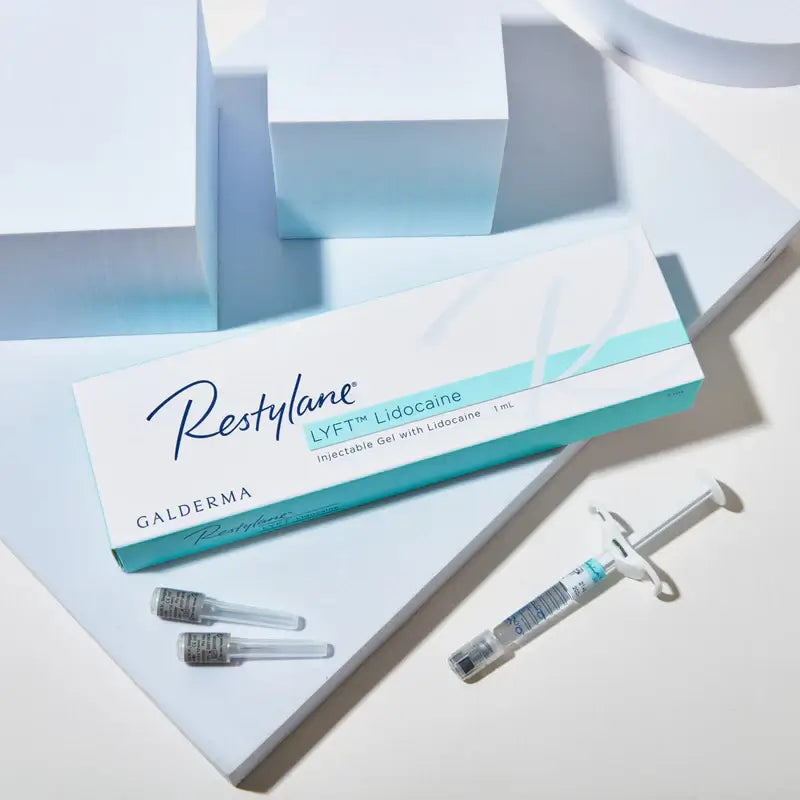Restylane Galderma injectable gel packaging with syringe and cartridges on a light background. Dermal filler for deep folds and wrinkles.